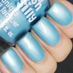 May include: A bottle of light blue nail polish with a shimmery finish. The bottle is labeled "Sally Hansen Salon Effects Unique Lacquer 0.5 fl. oz."
