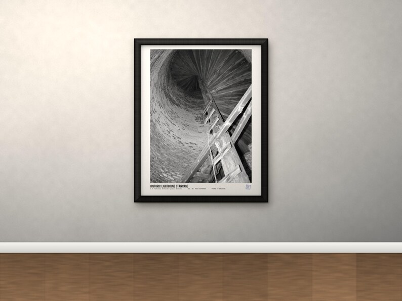 May include: A black and white framed print titled HISTORIC LIGHTHOUSE STAIRCASE, featuring a low-angle view of a spiraling wooden staircase inside a stone tower. The composition captures the vertical ascent of the stairs against the textured wall.