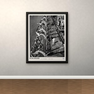May include: A black and white framed print titled BOAT DRILL BEFORE SAILING, depicting a high-angle view of multiple lifeboats filled with people alongside a large ship deck, with individuals standing on the deck during a maritime safety exercise.