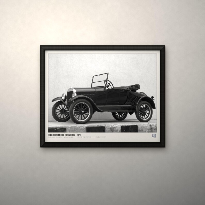 May include: A black and white framed print featuring a side profile of a 1926 Ford Model T Roadster. The text at the bottom reads 1926 FORD MODEL T ROADSTER 1926. The vintage automobile is depicted with spoked wheels, a folding windshield, and an open-top body style, presented within a simple black frame.