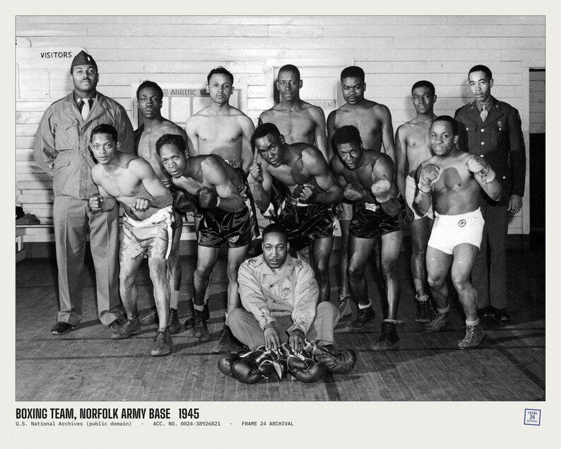 May include: A black and white photograph of a boxing team at the Norfolk Army Base in 1945. The group includes several boxers in trunks and gloves, and two individuals in military uniforms. The text reads: BOXING TEAM, NORFOLK ARMY BASE 1945.