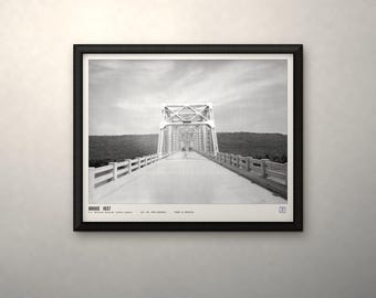 May include: A black and white framed print featuring a perspective view of a truss bridge. The text at the bottom reads BRIDGE 1937, U.S. National Archives (public domain), LOC NO. OREG-REGINALD, PRINT IS ARCHIVAL. The bridge has a metal structure and railings.