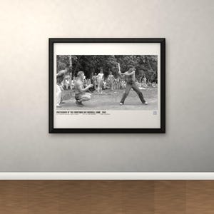 May include: A black and white framed photograph of a baseball game in progress with a batter and catcher, featuring the text: PHOTOGRAPH OF THE CHRISTMAS DAY BASEBALL GAME 1943. U.S. MARINE CORPS PHOTO. NO. 66-1943-1225. PRINT IN AMERICA.