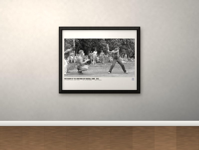 May include: A black and white framed photograph of a baseball game in progress with a batter and catcher, featuring the text: PHOTOGRAPH OF THE CHRISTMAS DAY BASEBALL GAME 1943. U.S. MARINE CORPS PHOTO. NO. 66-1943-1225. PRINT IN AMERICA.