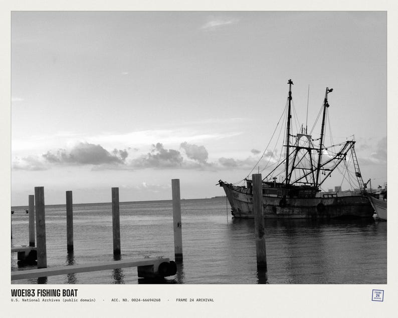 May include: A black and white photograph of a fishing boat moored near wooden pilings in calm water. The text WOE183 FISHING BOAT, U.S. National Archives (public domain), ACC. NO. 0024-66694268, FRAME 24 ARCHIVAL is printed at the bottom of the image.