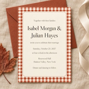 Puede incluir: Una tarjeta de invitación de boda rectangular con un borde de cuadros vichy rojo y blanco, que presenta el texto: Together with their families, Isabel Morgan & Julian Hayes, invite you to celebrate their marriage, Saturday, October 23, 2027, at four o'clock in the afternoon, Rosewood Hall, Hudson Valley, New York, Dinner and dancing to follow.