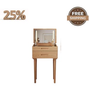 May include: A light wood vanity table featuring a flip-top mirror that reveals a storage compartment. The unit includes two horizontal drawers with integrated handles and is supported by four tapered legs. The surface holds various cosmetic items.