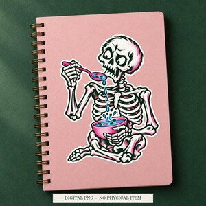 Skeleton Soup Strainer artwork decorating a notebook as a white outlined sticker. Digital PNG project example; notebook and sticker are not included.