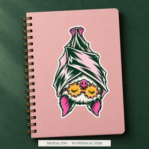 Bat Sleep Mask artwork decorating a notebook as a white outlined sticker. Digital PNG project example; notebook and sticker are not included.