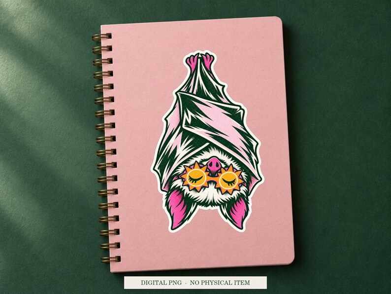 Bat Sleep Mask artwork decorating a notebook as a white outlined sticker. Digital PNG project example; notebook and sticker are not included.