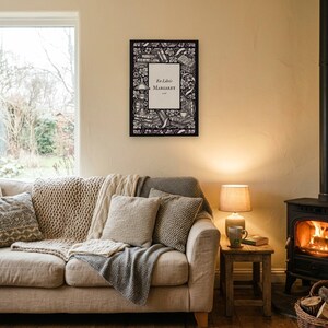 Personalised ex libris bookplate print in engraved ink on cream: a border of stacked books, a reading lamp and a cup of tea, with Ex Libris above and a mum's name and a year set in the centre.