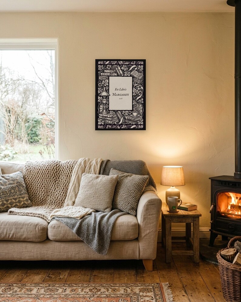 Personalised ex libris bookplate print in engraved ink on cream: a border of stacked books, a reading lamp and a cup of tea, with Ex Libris above and a mum's name and a year set in the centre.