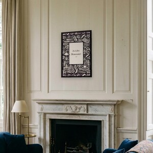 Personalised ex libris bookplate print in engraved ink on cream: a border of stacked books, a reading lamp and a cup of tea, with Ex Libris above and a mum's name and a year set in the centre.