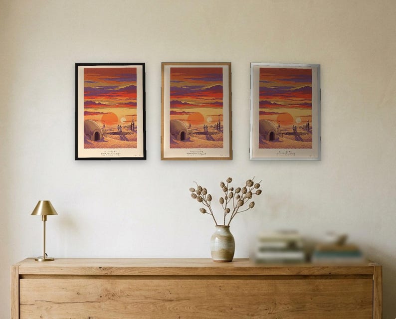 Twin suns sci fi art print in French colour lithograph style: two figures watch twin suns set over a desert homestead of domes and water towers at dusk. Shown framed in black, white or natural oak and unframed, with the style reference and behind-the-scenes shots.