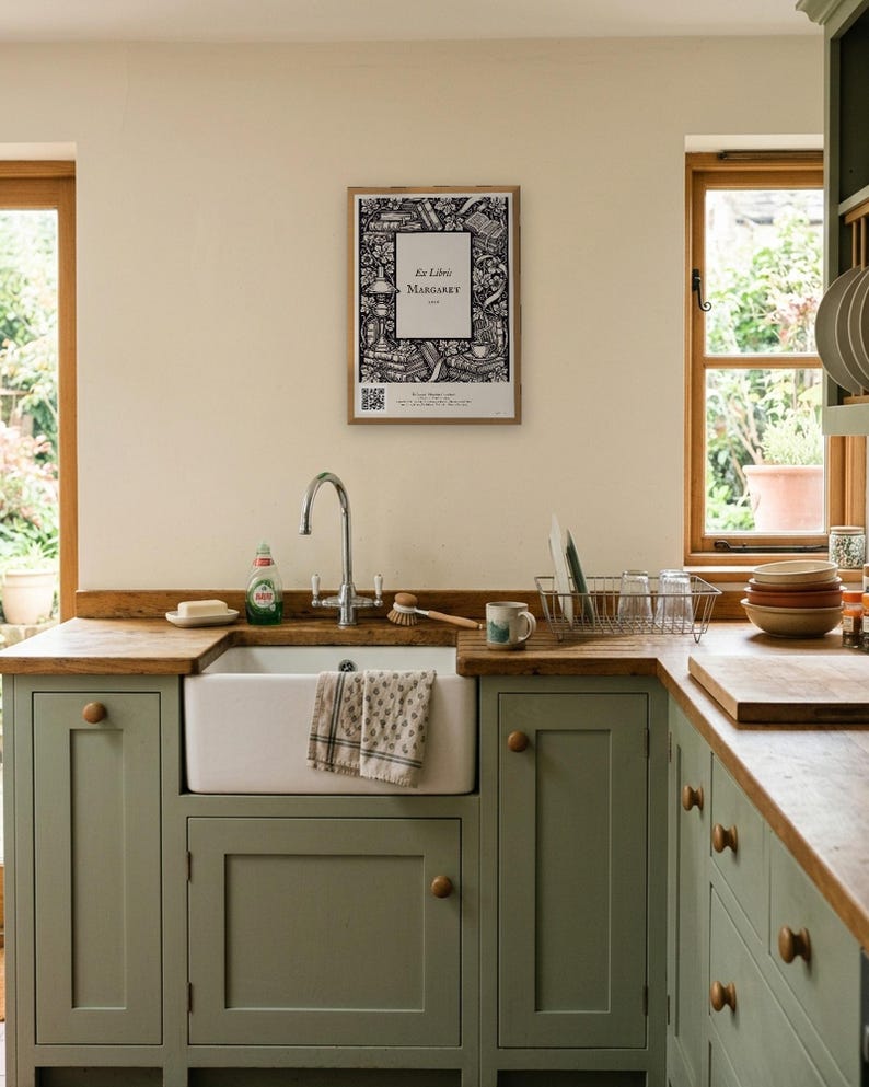 Personalised ex libris bookplate print in engraved ink on cream: a border of stacked books, a reading lamp and a cup of tea, with Ex Libris above and a mum's name and a year set in the centre.