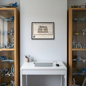 Personalised allotment plan print in blue-and-white technical lines: a blueprint of an allotment with numbered beds, a shed, water butt and compost heap, and a title block for the site name, plot number and owner.