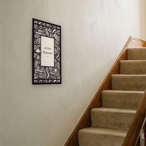 Personalised ex libris bookplate print in engraved ink on cream: a border of stacked books, a reading lamp and a cup of tea, with Ex Libris above and a mum's name and a year set in the centre.
