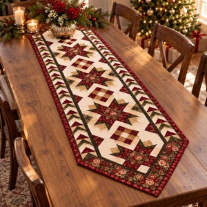 May include: A quilted table runner featuring a repeating pattern of dark red and green stars, floral fabric accents, and geometric borders in cream, red, and dark green, laid flat on a wooden dining table with a festive centerpiece.