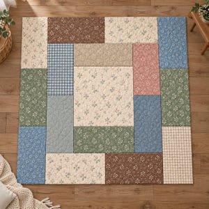 May include: A rectangular quilted floor mat featuring a patchwork design of various fabric panels. The patterns include small floral prints in brown, cream, green, pink, and blue, alongside blue and white gingham and beige checkered squares.
