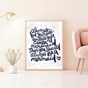 May include: A framed print with a white background and black text that reads "Always be yourself unless you can be a mermaid then you should always be a mermaid". The text is in a handwritten style with a heart at the end.