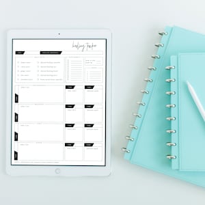 May include: A white iPad with a black screen displaying a healing tracker. The tracker includes sections for daily detox, healing protocol, supplements, time, how I feel, and adrenal snack. The iPad is on a white surface.