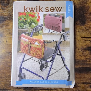 May include: A Kwik Sew K4381 sewing pattern envelope for a walker caddy and bag. The cover features images of a purple walker equipped with a red and gold paisley patterned caddy and a solid mauve storage bag attached to the frame handles.