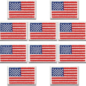 May include: Ten small embroidered American flag patches. Each patch is white with red and blue stitching. The patches are rectangular and have a white border.