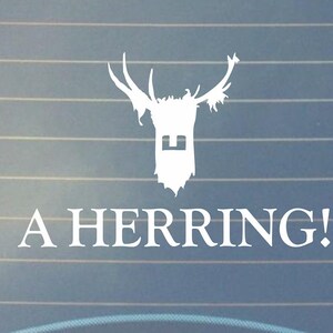 May include: White vinyl sticker on a blue car window. The sticker features a stylized deer head with antlers and the text "A HERRING!"