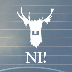 May include: White vinyl sticker of a stag head with antlers and the word "NI!" underneath. The stag head has a square shape in the middle of its face.