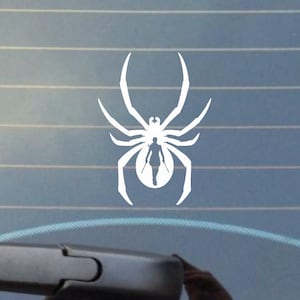 May include: White vinyl sticker of a spider with a woman silhouette inside. The spider has eight legs and a round body.