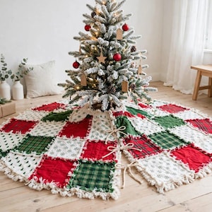 May include: A round Christmas tree skirt featuring a patchwork design of red, dark green, and white fabric squares. The squares include patterns of plaid, snowflakes, and solid colors with frayed, exposed seams and three tie closures.