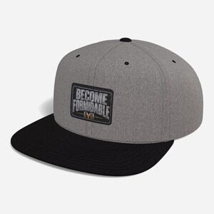 May include: A heather gray baseball cap with a black flat brim and a black button on top. The front features a rectangular patch with a black border and the white text BECOME FORMIDABLE, with a small graphic element below the text.