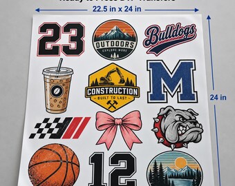 May include: A 22.5 inch by 24 inch white gang sheet featuring various DTF transfers including the number 23, a mountain outdoors emblem, Bulldogs text, an iced coffee, a construction logo, a large letter M, a checkered flag, a pink bow, a bulldog head, a basketball, the number 12, and a sunset landscape.