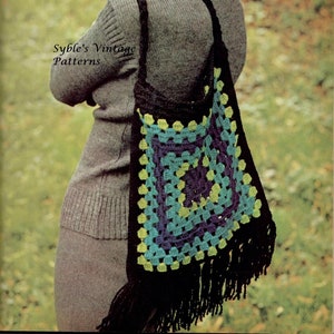 May include: A black crochet tote bag with a green, blue, and purple granny square design. The bag has black fringe and a long strap.