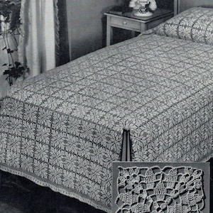 Op de afbeelding: Een wit gehaakt bedsprei met een delicaat bloemenpatroon. Het bedsprei is te zien op een bed met een wit kussen. Een close-up van het haakpatroon is te zien in de rechterbenedenhoek van de afbeelding.