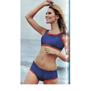 May include: A blue and red swimsuit with a halter top and high-waisted bottoms. The swimsuit is made of a stretchy fabric and has a sporty look.