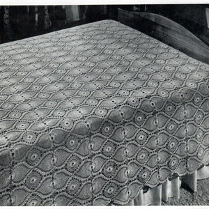 May include: A white crocheted bedspread with a repeating pattern of ovals and circles.