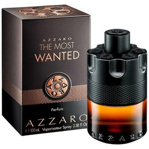 May include: A bottle of Azzaro The Most Wanted parfum with a black revolver cylinder cap and amber liquid, next to a dark brown box featuring the text Azzaro The Most Wanted, 100 mL, Vaporisateur Spray, and 3.38 Fl. Oz in white and gold lettering.