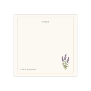 May include: A square notepad with a cream-colored background and a thin gold border. The word NOTES is printed in black at the top center. The text PETALBOUND PRESS is in the bottom left corner, and a lavender sprig is in the bottom right.