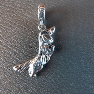 May include: A silver squirrel charm, designed to be attached to a bracelet or necklace. The charm depicts a squirrel standing upright, with its paws together. The squirrel has detailed fur and a long tail. The charm is made of a shiny metal.