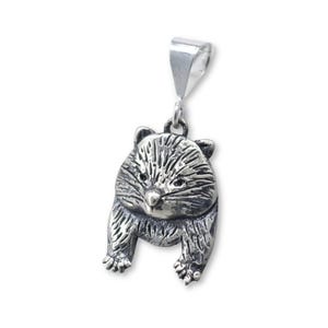 May include: A silver-colored pendant in the shape of a raccoon. The pendant has detailed fur texture and a small loop at the top for a chain. The raccoon is depicted in a standing pose.