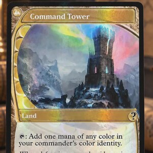 May include: A Command Tower trading card featuring a stone tower on a rocky cliff under a colorful aurora sky. The card text reads: Command Tower, Land, Add one mana of any color in your commander’s color identity. When defeat is near and guidance is scarce, all eyes look in one direction.