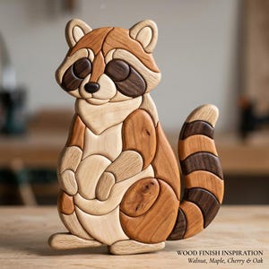May include: A handcrafted wooden raccoon figurine composed of interlocking pieces in varying natural wood tones including light maple, medium cherry, and dark walnut. The text at the bottom reads: WOOD FINISH INSPIRATION Walnut, Maple, Cherry & Oak.