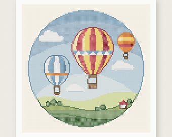 May include: A cross stitch pattern featuring three hot air balloons in a blue sky with white clouds above a green landscape. The balloons are red and yellow, blue and white, and orange and yellow. The text reads PDF PATTERN INSTANT DOWNLOAD.