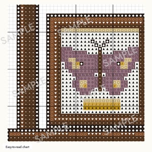 May include: A cross-stitch pattern chart featuring a central purple butterfly design on a white grid background. The design is framed by a brown border decorated with white hearts, circles, and crosses. The chart includes the text Easy-to-read chart.