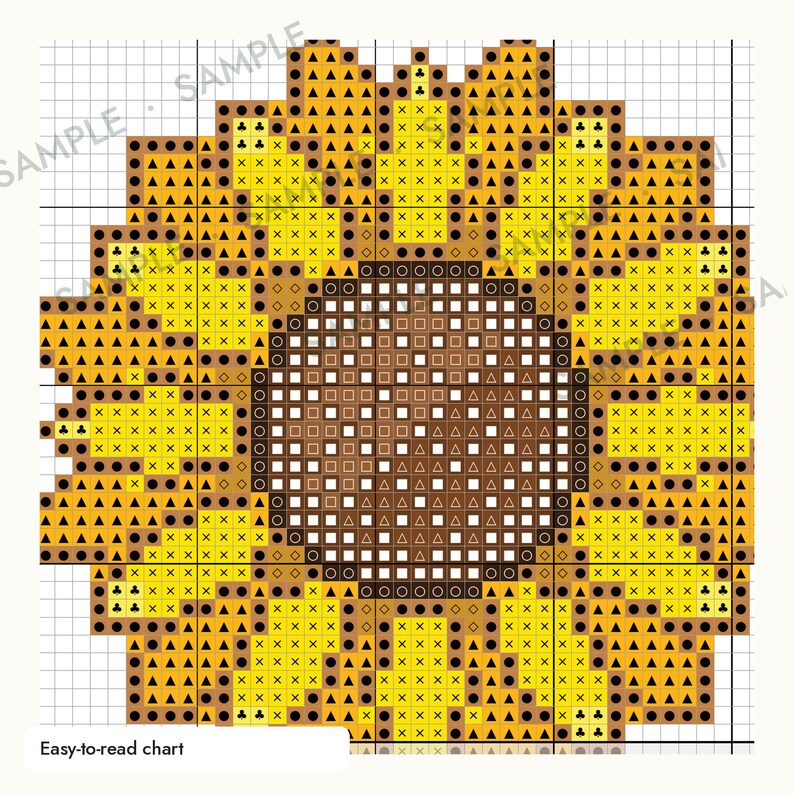 May include: A cross-stitch pattern chart of a sunflower on a white grid background. The design features a dark brown circular center with white square symbols and yellow petals with black triangle, circle, and cross symbols. Text reads Easy-to-read chart.
