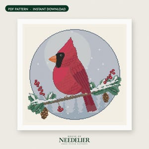 May include: A cross stitch pattern featuring a red cardinal bird perched on a snowy pine branch with red berries and pinecones, set against a circular light blue background with white stars and the text PDF PATTERN INSTANT DOWNLOAD.