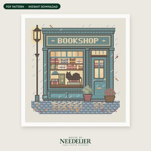 May include: A cross-stitch pattern featuring a teal bookstore storefront with the word BOOKSHOP above the window. The design includes a black cat in the window, a tall street lamp, potted plants, and a cobblestone sidewalk with scattered leaves.