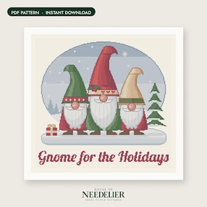 May include: A cross stitch pattern featuring three gnomes with long white beards and pointed hats in red, green, and beige. The design includes a small gift box, a pine tree, and the text Gnome for the Holidays. The background is a snowy scene.
