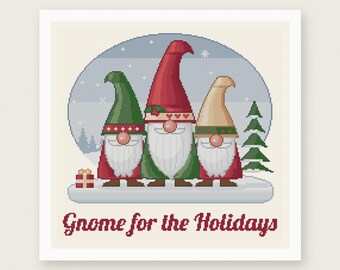 May include: A cross stitch pattern featuring three gnomes with long white beards and pointed hats in red, green, and beige. The design includes a small gift box, a pine tree, and the text Gnome for the Holidays. The background is a snowy scene.